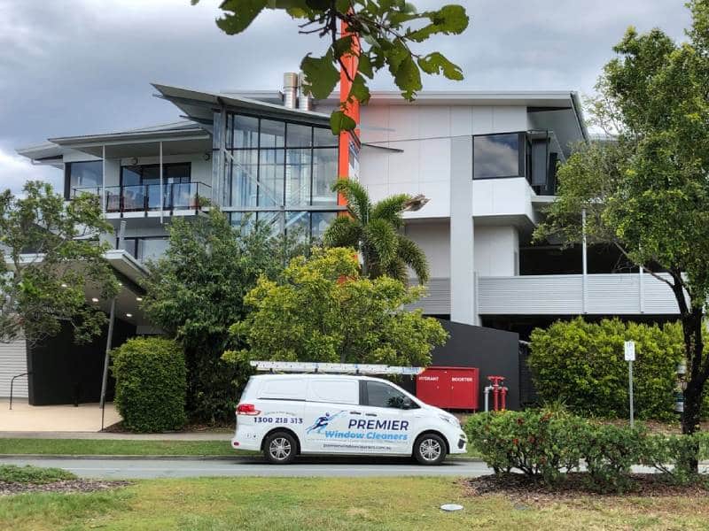 Huge and luxurious home visited by a window cleaning service company van